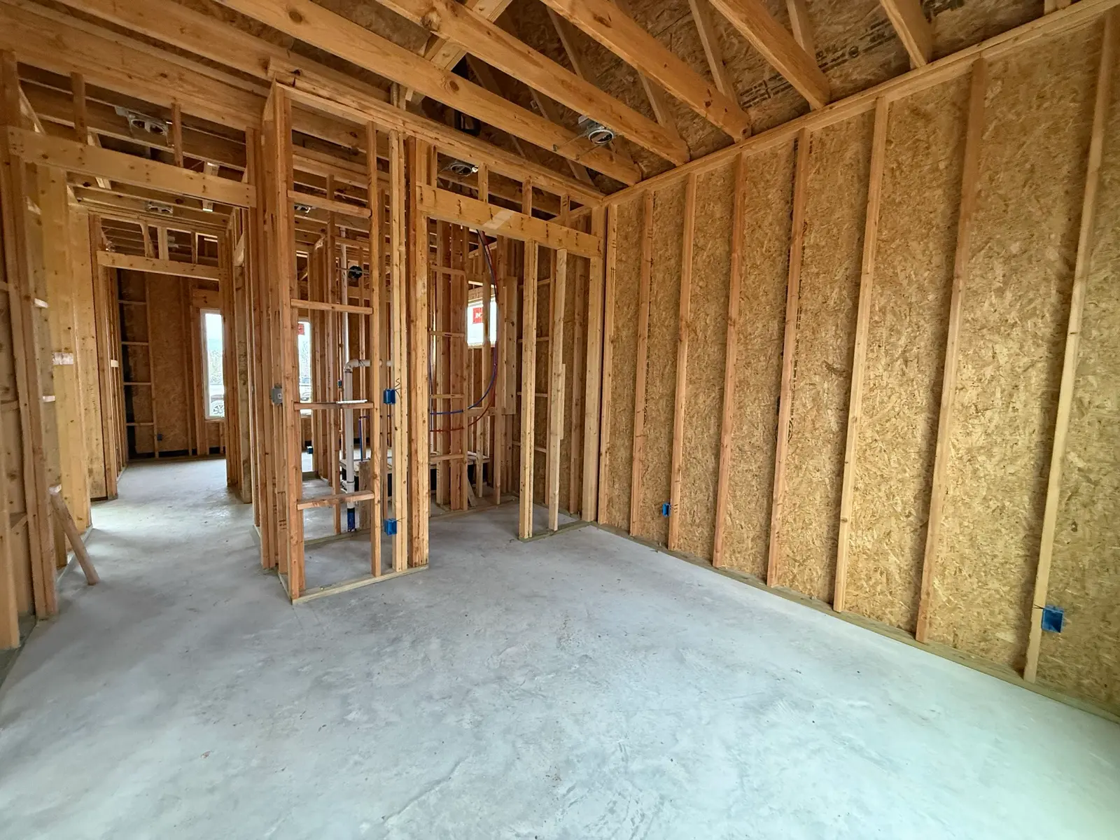 TKG Custom Homes interior during pre-electric walkthrough with outlet placement markings