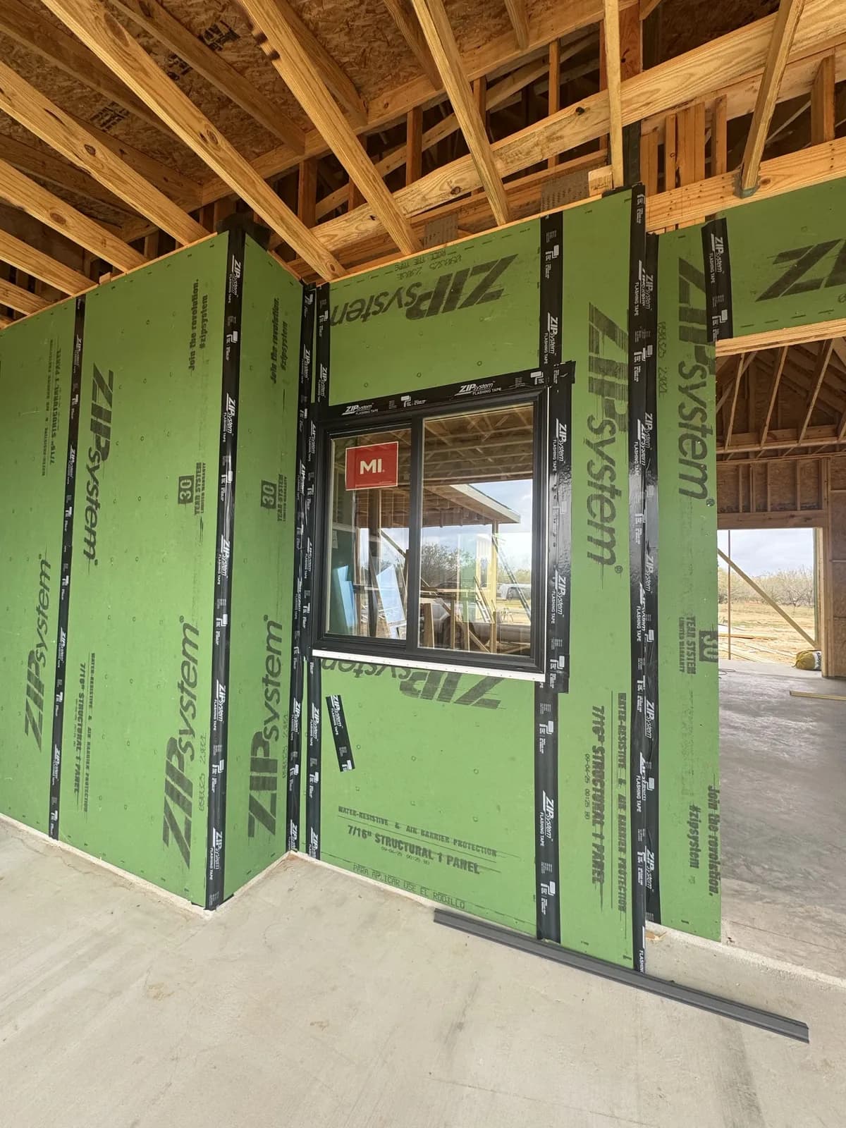 ZIP System green structural sheathing panels with flashing tape on Ryan's custom home build in Seguin TX